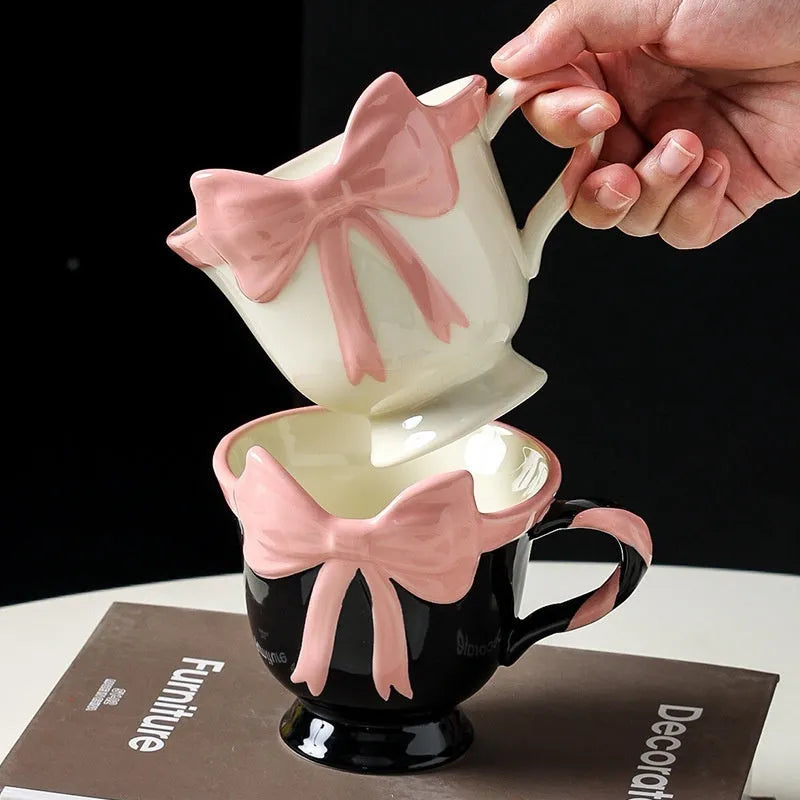 Ceramic mug with a cute girl heart bow design in white powder and black pink colours.