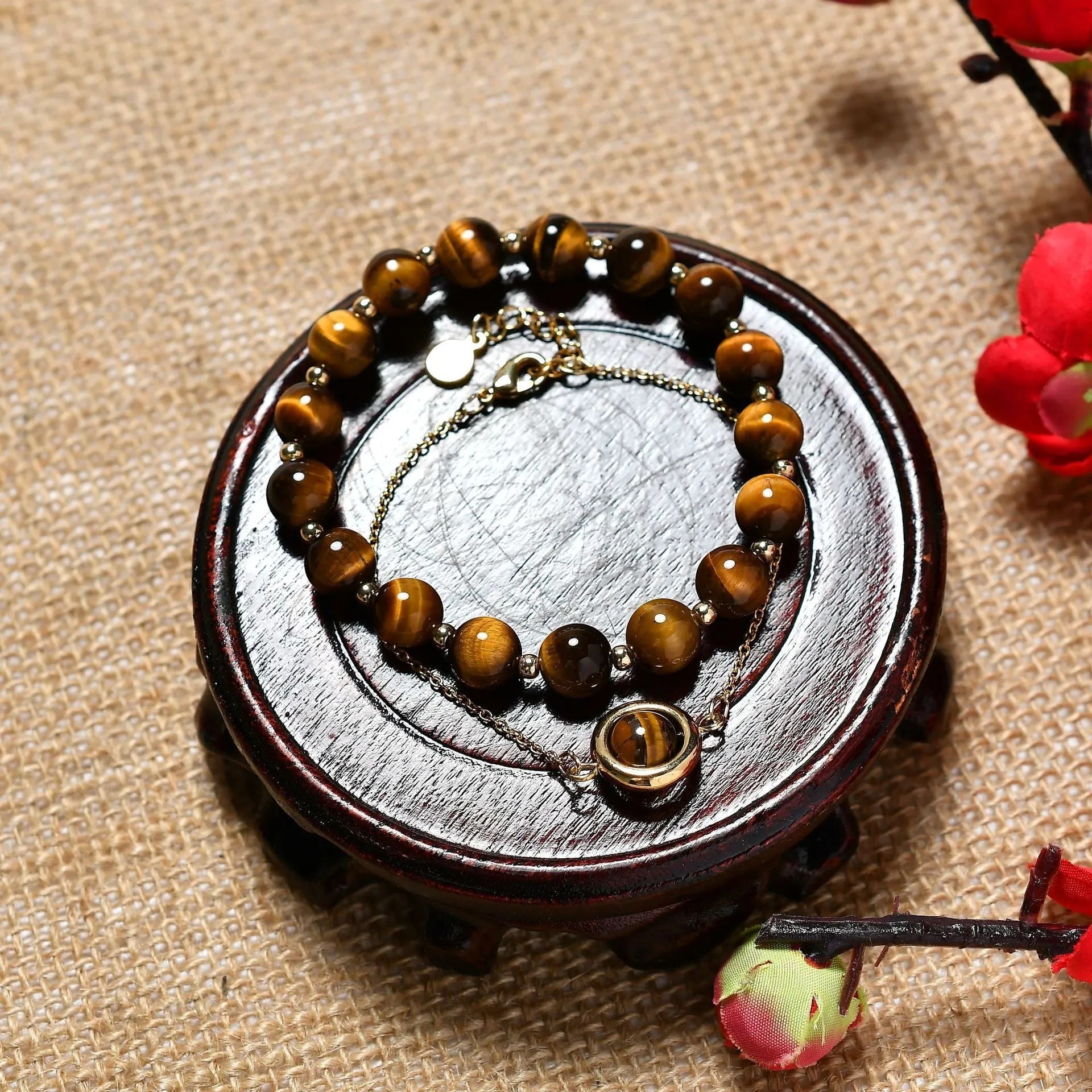 Close-up of a women's double-layer copper bracelet with lucky beads and an electroplated gold finish in a strawberry quartz colour.