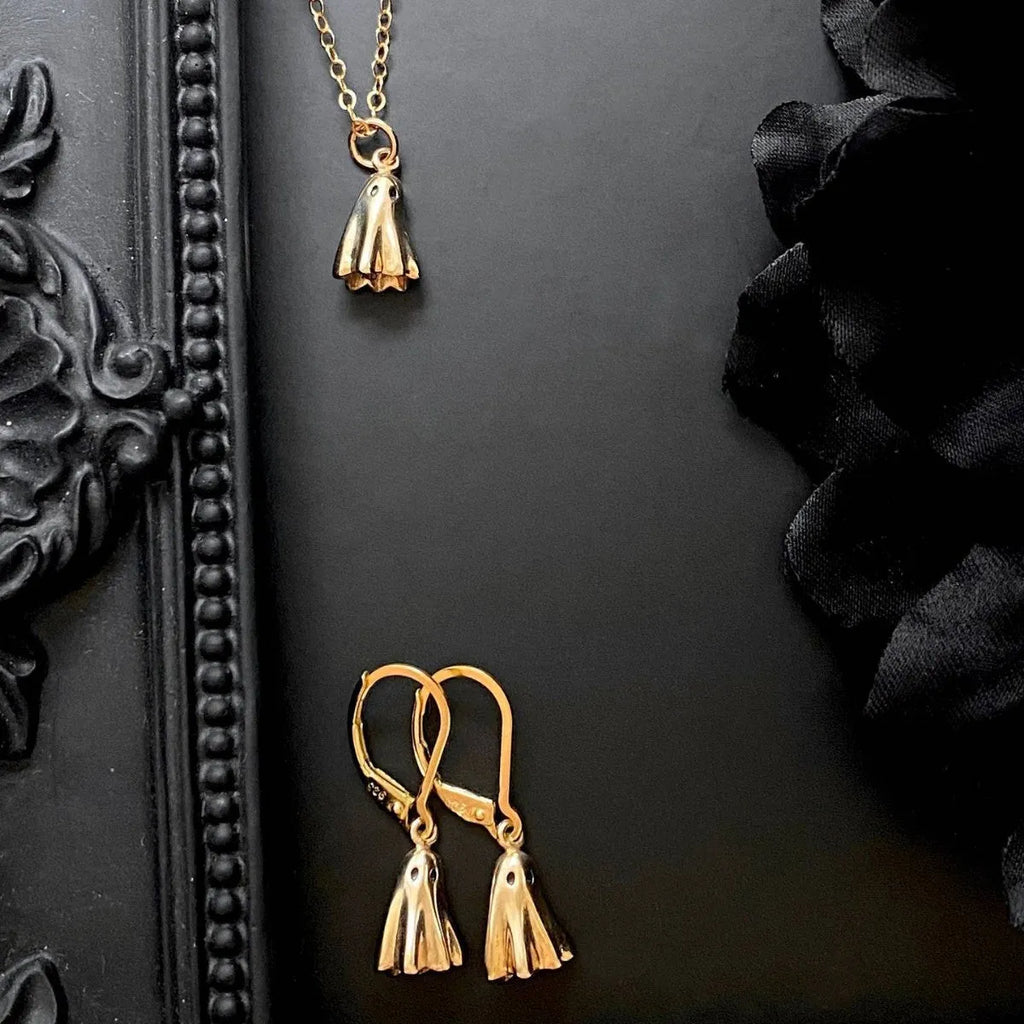 A modern ghost pendant necklace on a stainless steel chain, showing the titanium steel electroplated pendant detail.