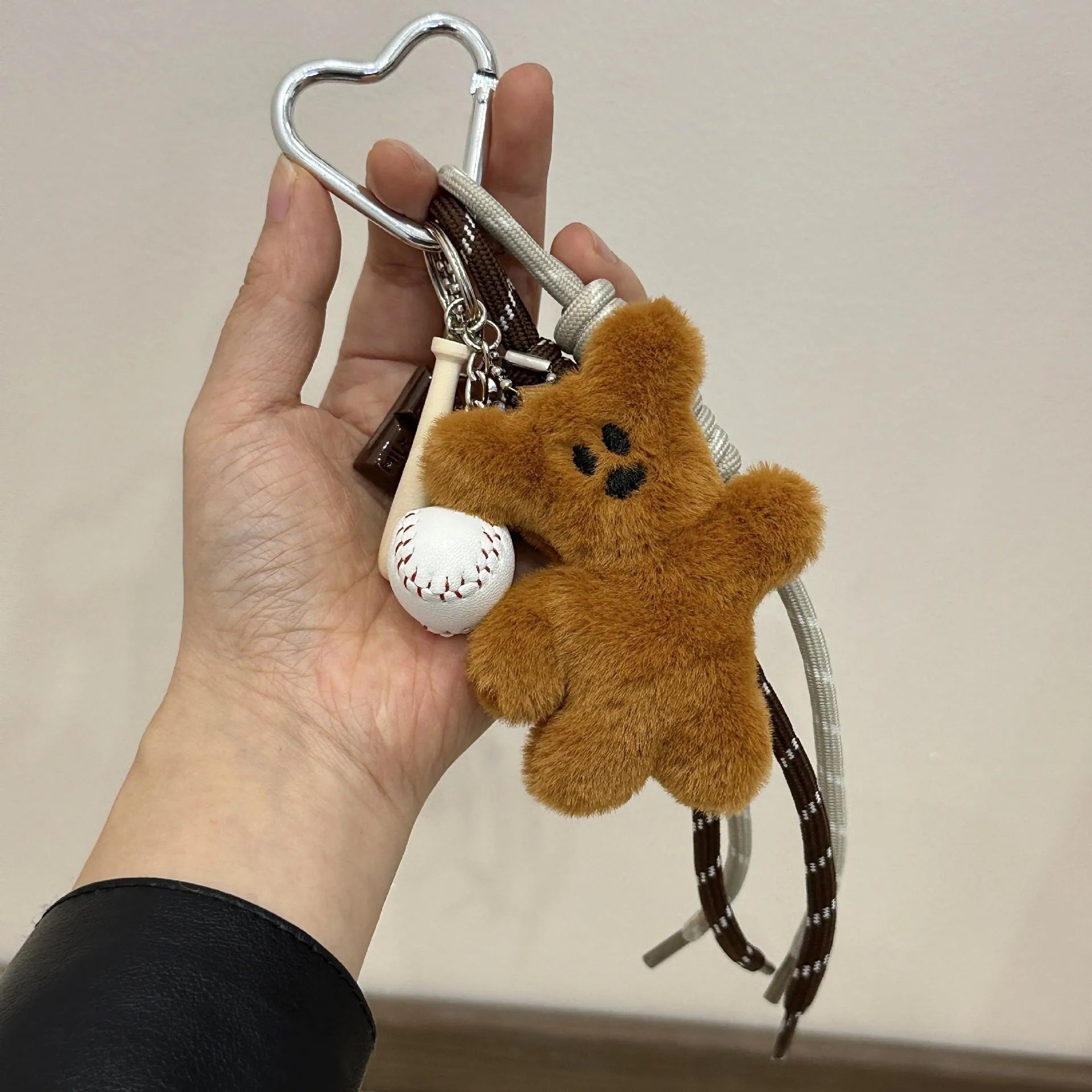 Brown plush bear pendant keychain attached to a bag, soft toy decoration