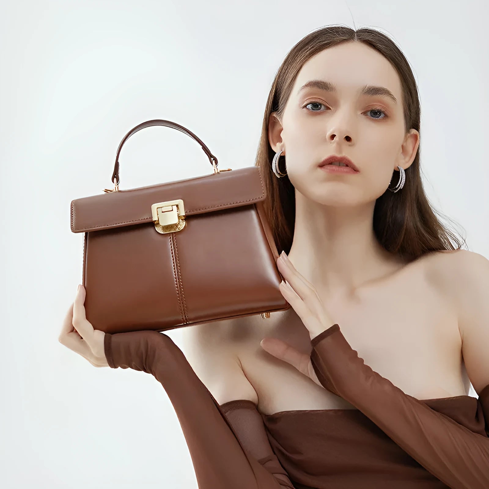 Dark brown women's genuine leather shoulder bag with a metal Vachette clasp, shown open to reveal an interior zippered pocket.