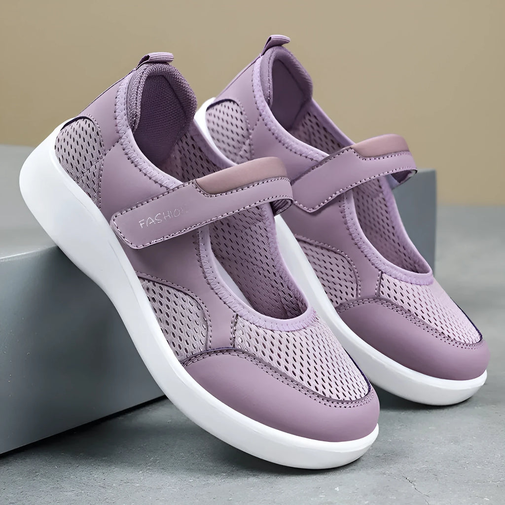 Women's low-top grey mesh casual trainers with Velcro fastening and a flat polyurethane sole.