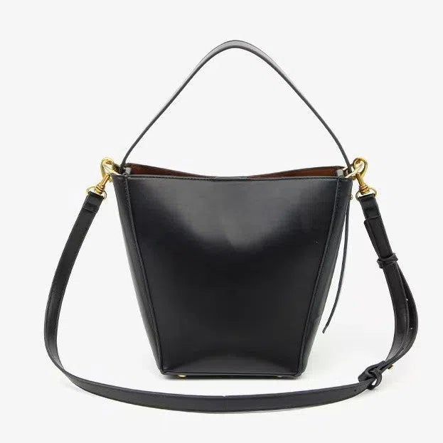 Urban minimalist bucket-style crossbody shoulder bag in PU with three-dimensional outer pocket, black colour option, flat lay view