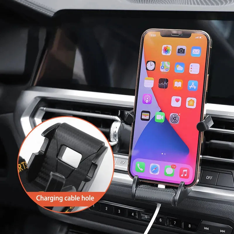 Gold car air vent phone holder with racing seat shape mounted on a car vent, showing 360-degree rotation.