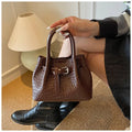 Soft PU bucket messenger handbag for women with spliced exterior and outer pocket, black colour option