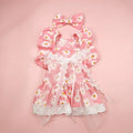 Breathable lace and plaid gauze dog skirt in Pink Daisy with matching bow necklace on a small dog
