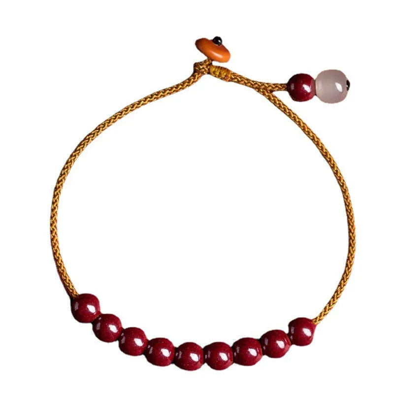 Hand-woven bracelet made of red cinnabar and raw Hetian Jade in a simple geometric shape.