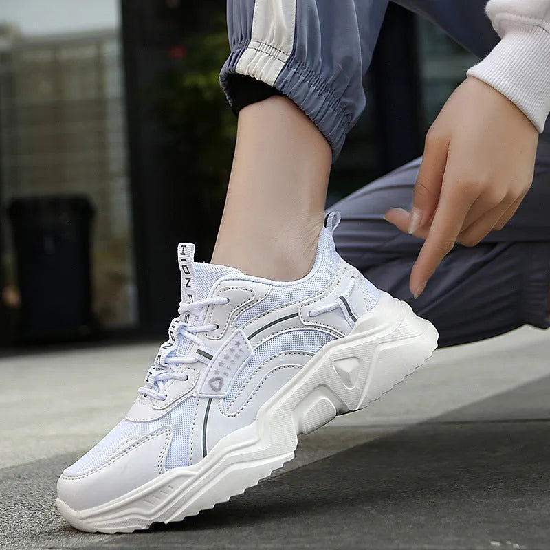 Women's white casual sports shoes with mesh upper, thick PU sole, and a buckle fastening.