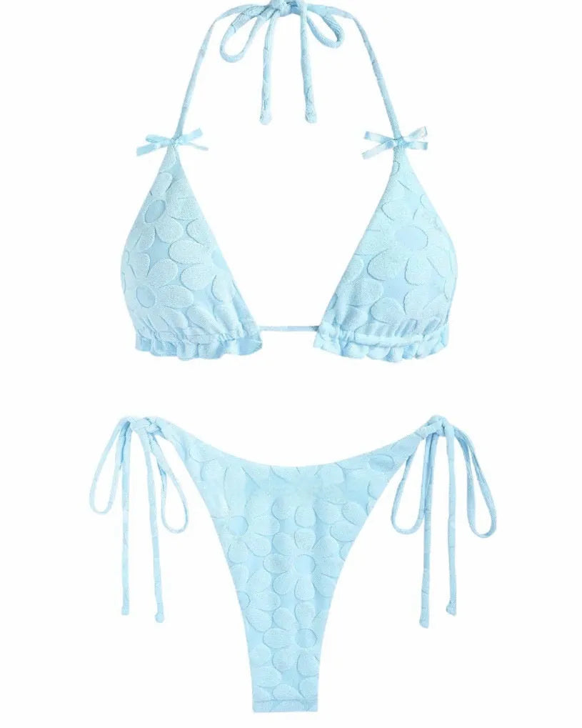 Women's light blue backless bikini swimsuit with strappy design on a mannequin.