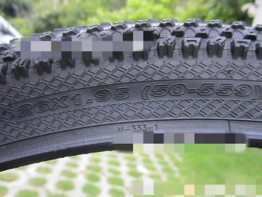 Ultralight puncture-resistant mountain bike tyre shown in black with white label option, for 26, 27.5 and 29-inch wheels.