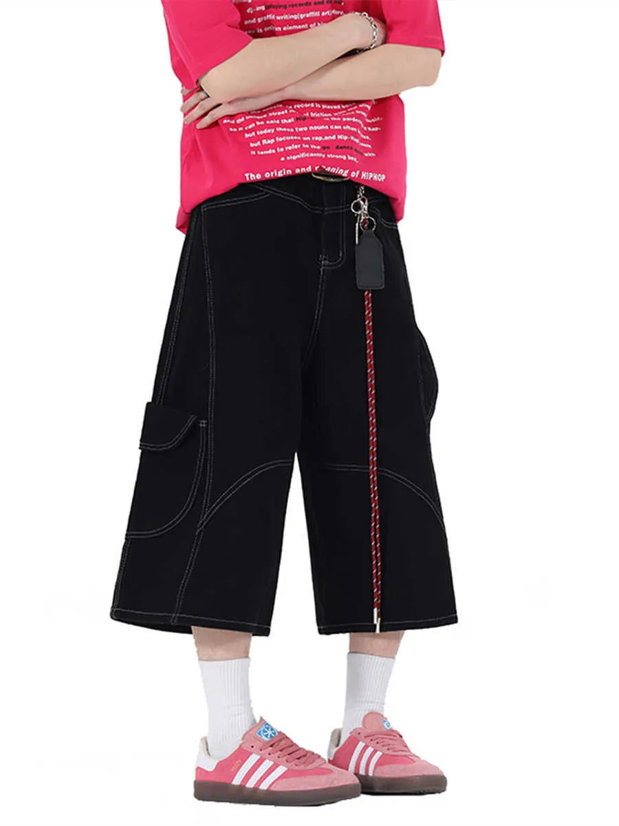 Men's red denim wide-leg cropped workwear shorts with multiple pockets on a mid waist