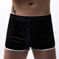 Men's grey three-point boxer shorts with a mid-rise waistband laid flat on a table.