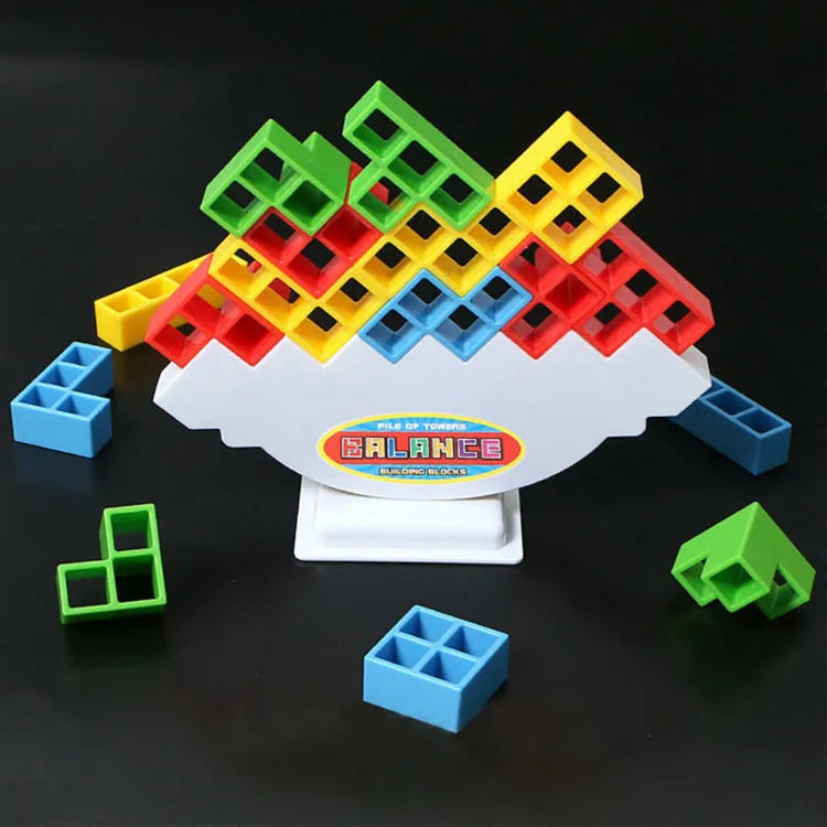 Plastic balance stacking game with coloured blocks on a tilting base, packed in a 26.5 cm box.