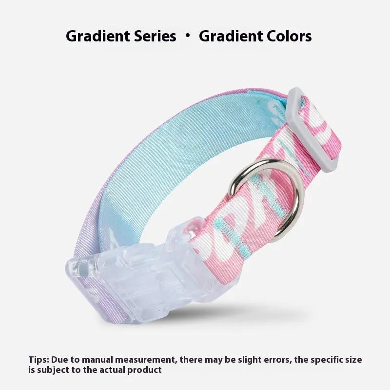 Adjustable nylon dog collar with blue to green gradient cartoon print and plastic buckle on a white background.