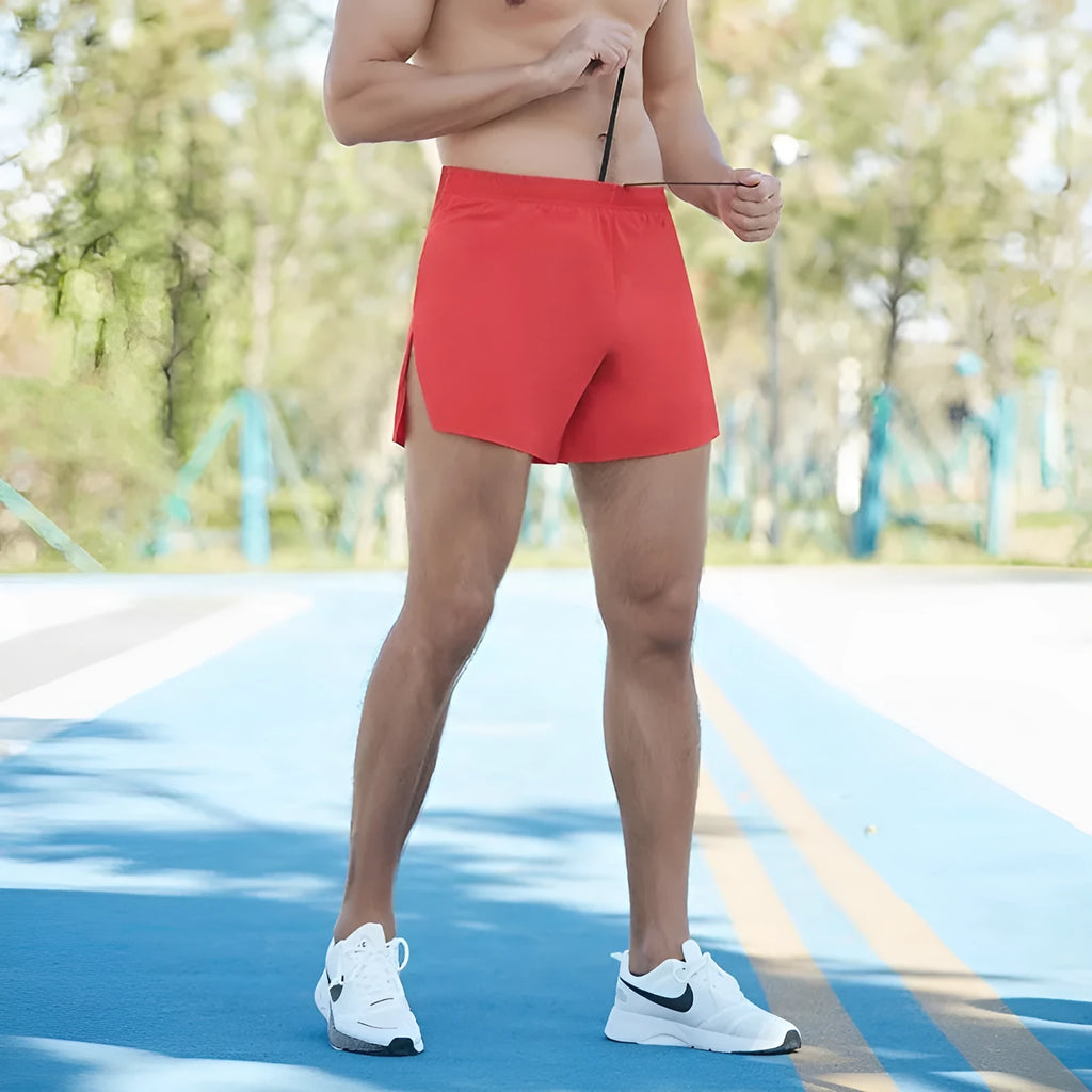 Man's high-waist loose fit off-road running shorts in black, showing quick-dry fabric and inner lining detail.