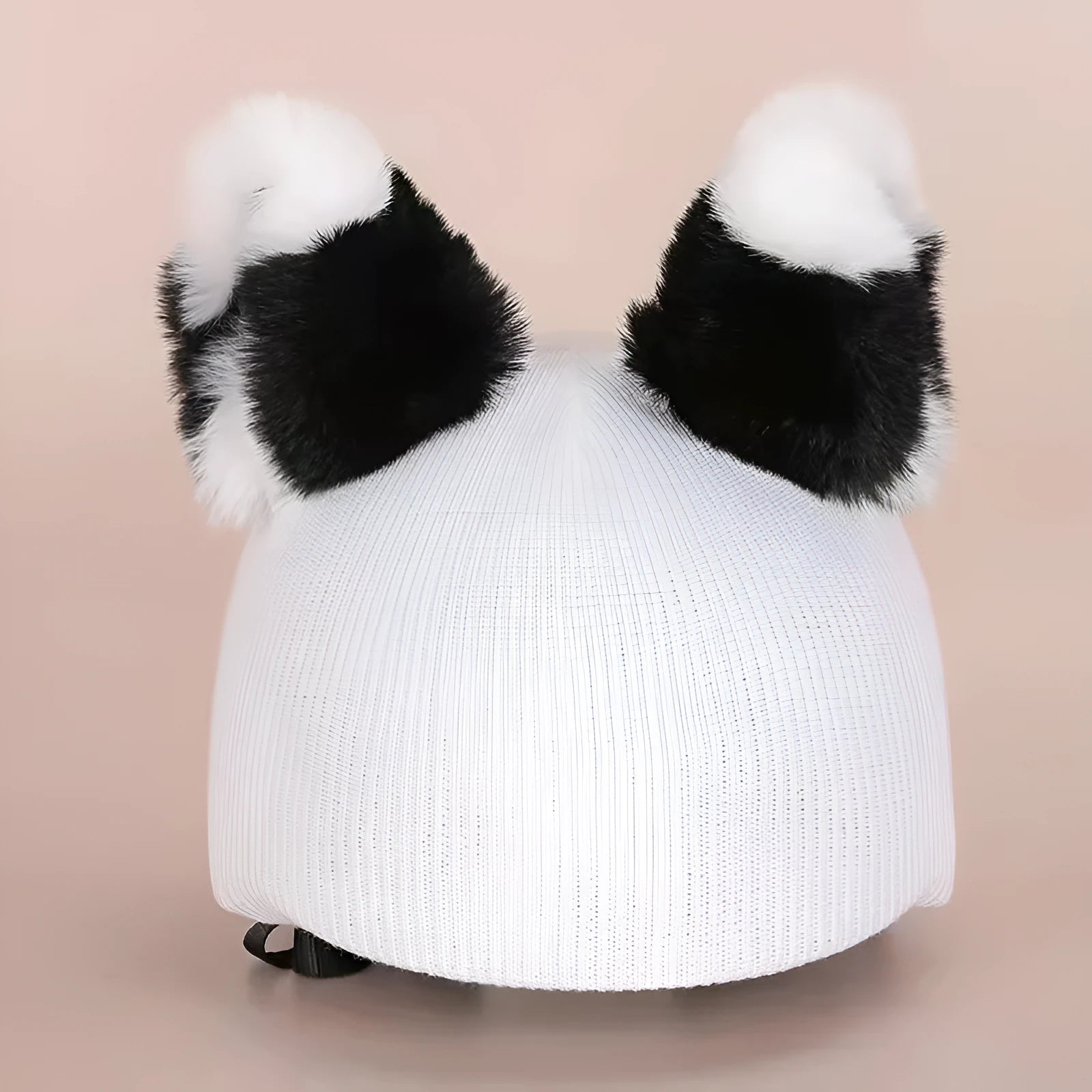 Colourful plush cartoon hat decoration sitting on top of a ski helmet