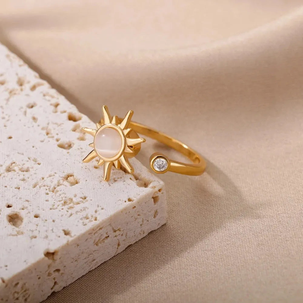 Adjustable decompression ring with rotatable band in gold or platinum finish