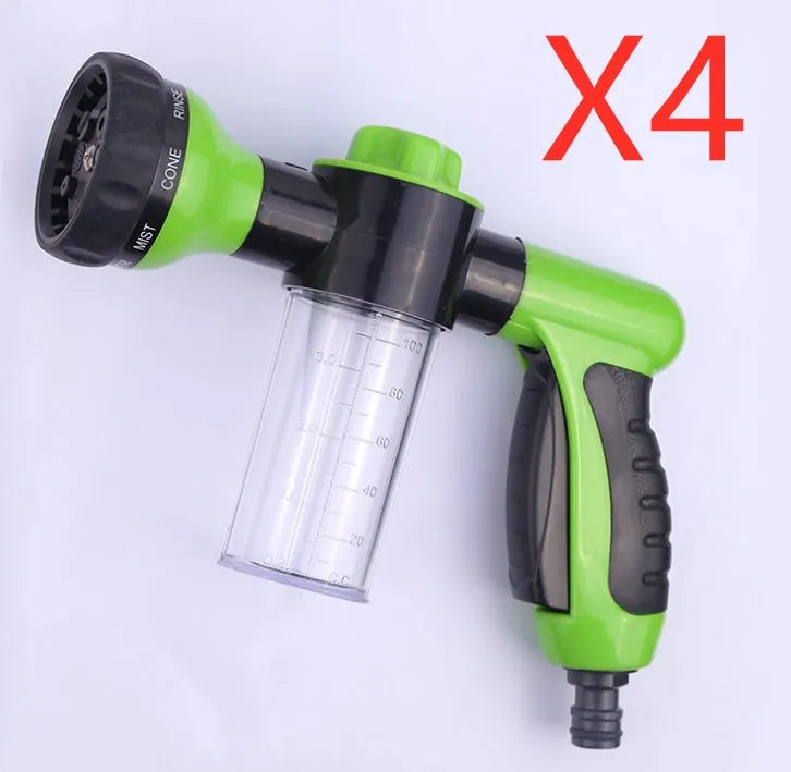 Green high-pressure foam spray gun with adjustable nozzle and attached water hose for car and garden cleaning.