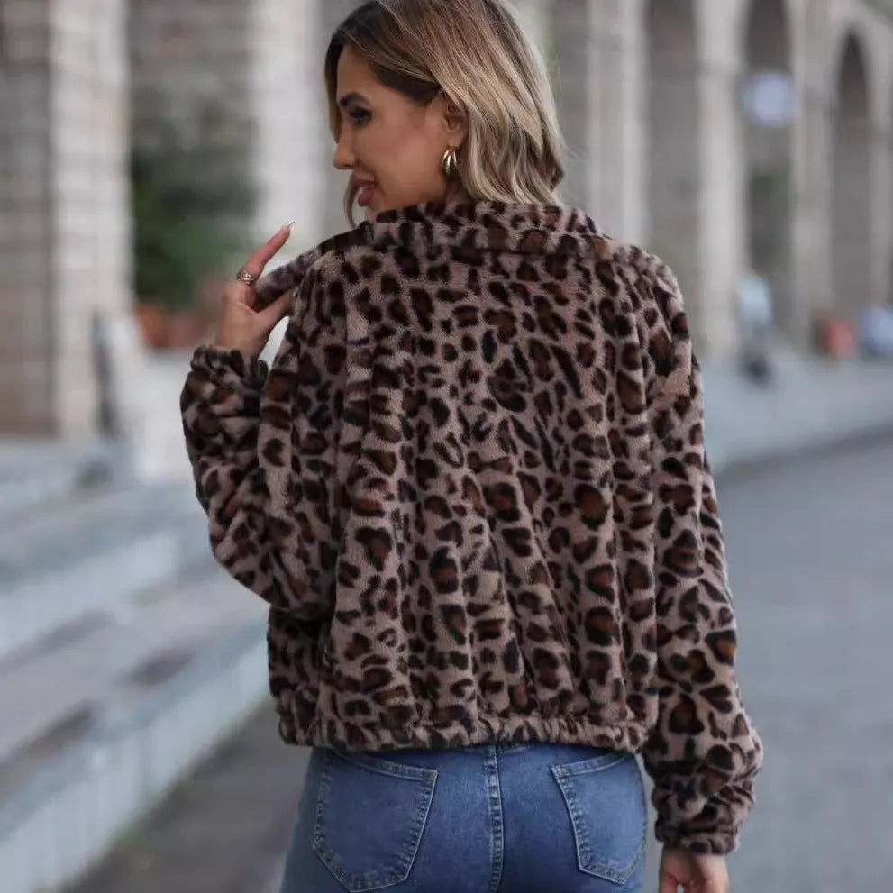 Women's loose fit leopard print plush coat with front zip and long sleeves.