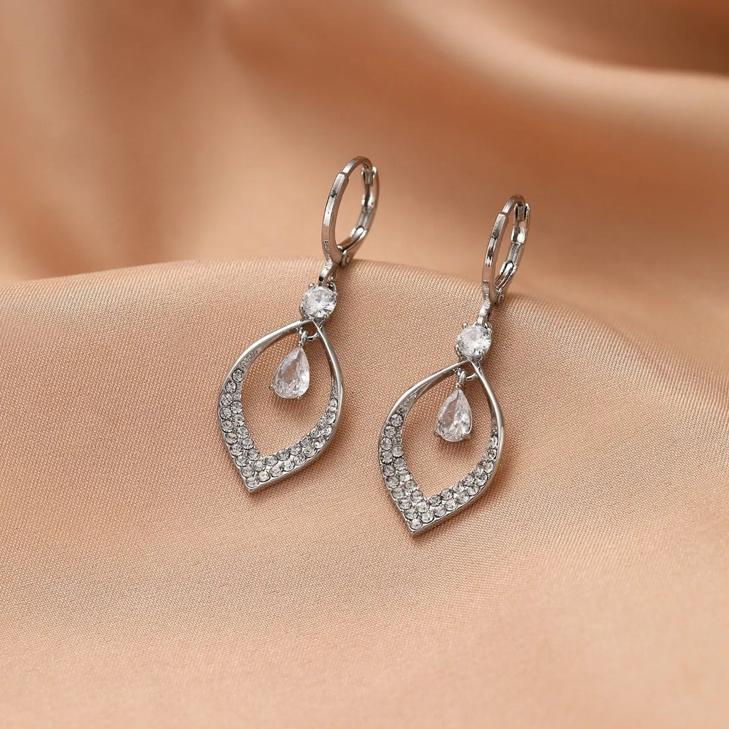 A pair of women's zircon water drop tassel earrings with gold-coloured buckles on a white background.
