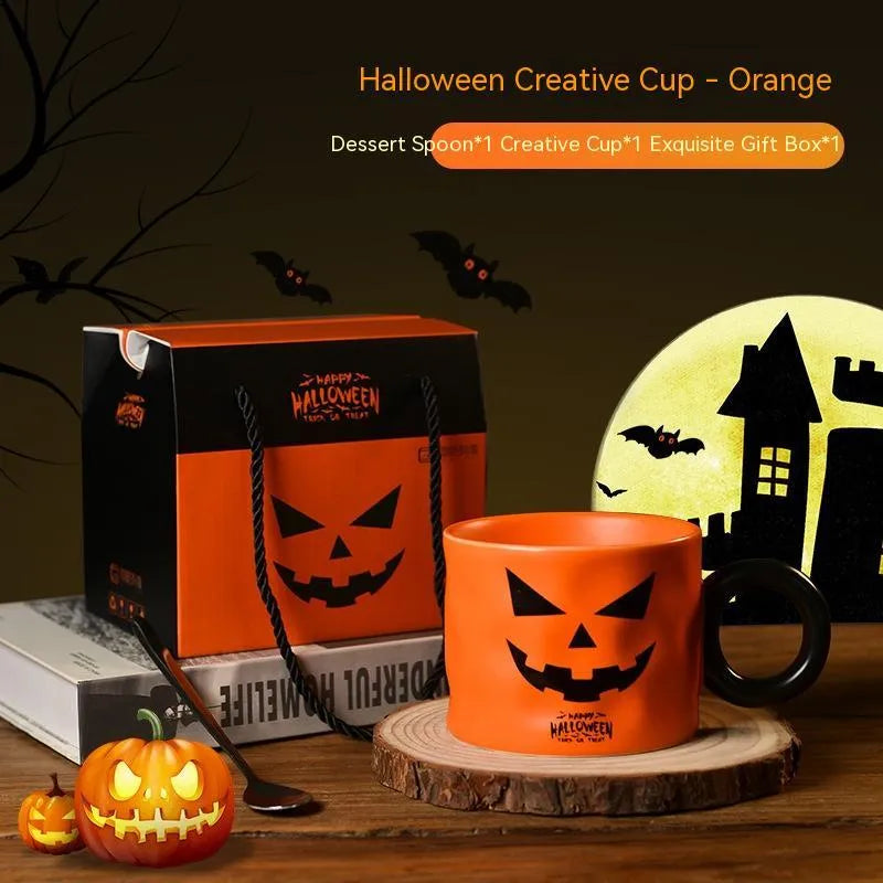 Orange ceramic pumpkin mug with handle on gift box with dessert spoon