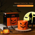 Orange ceramic pumpkin mug with handle on gift box with dessert spoon