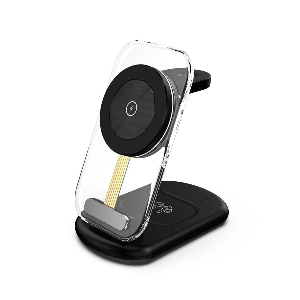Transparent folding magnetic wireless charger showing internal components, charging an iPhone and AirPods case on a desk.