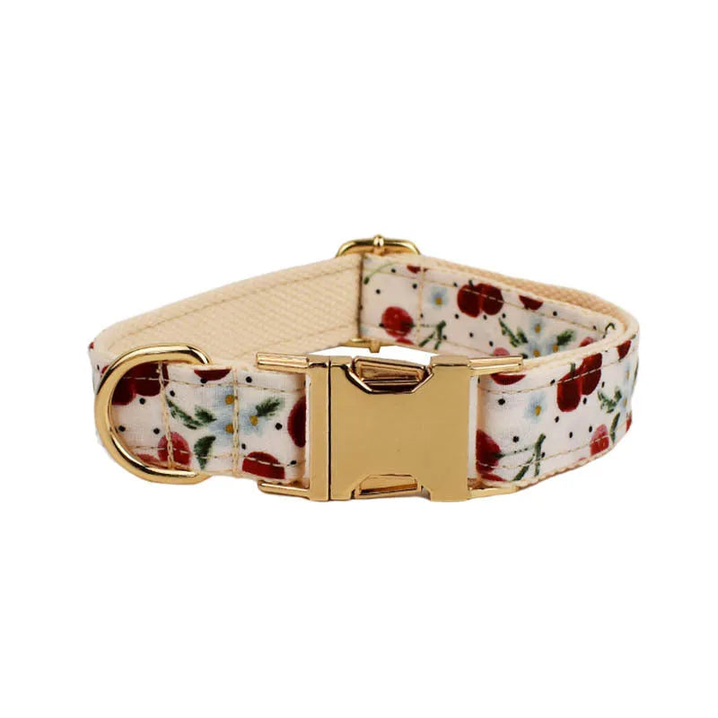 Red cherry printed dog collar and leash set with light gold buckle and bow on cloth material