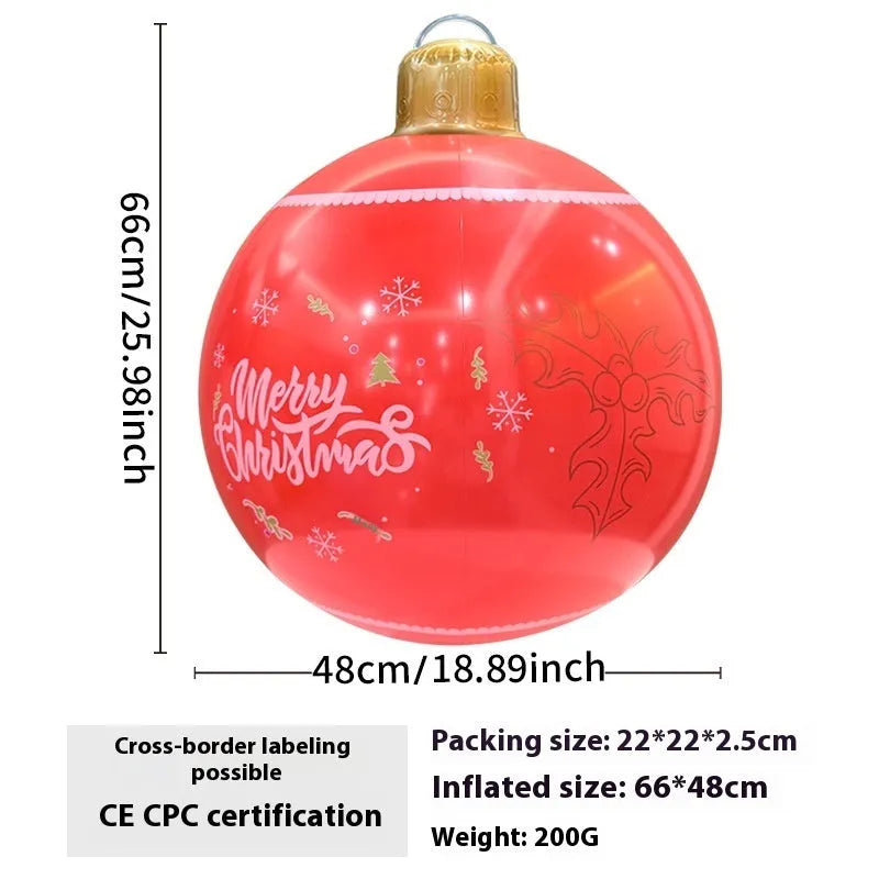 Large red and white inflatable Christmas ball with flashing lights standing in a garden.