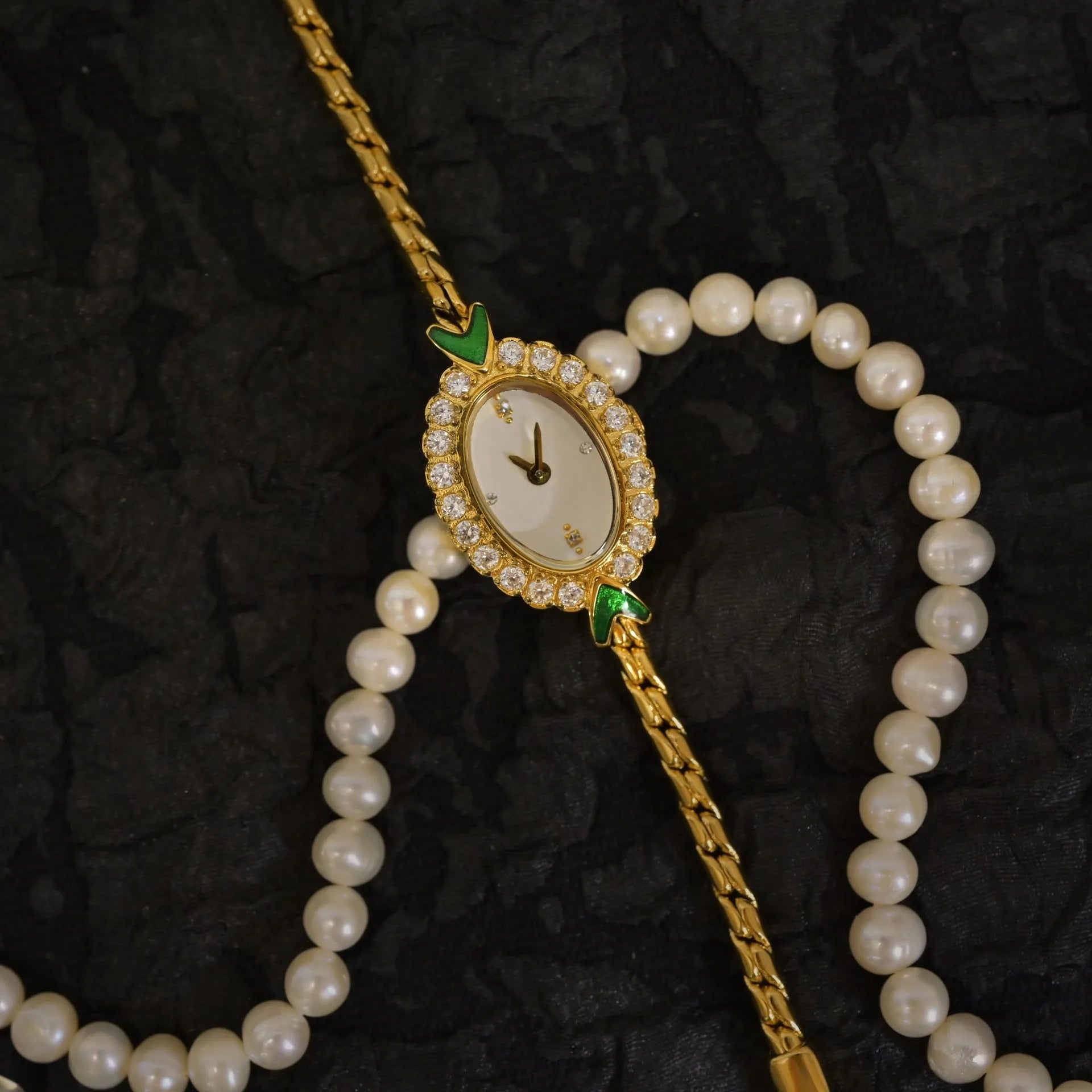 European small gold women's watch with handmade rhinestone inlay on a white background