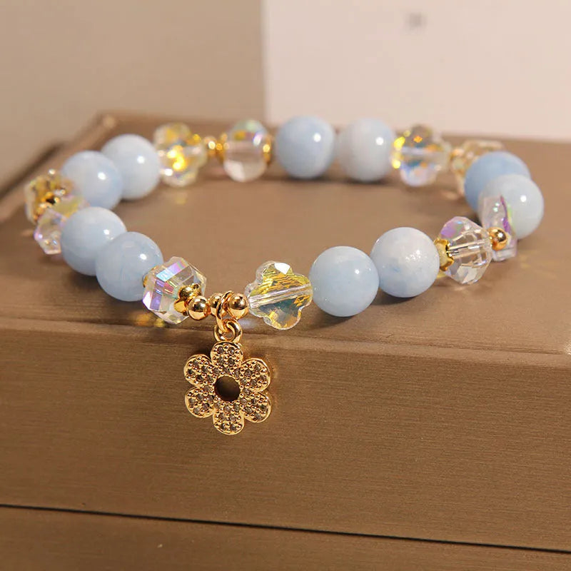 Aquamarine crystal bracelet with a four-leaf clover charm and pearl details for women.