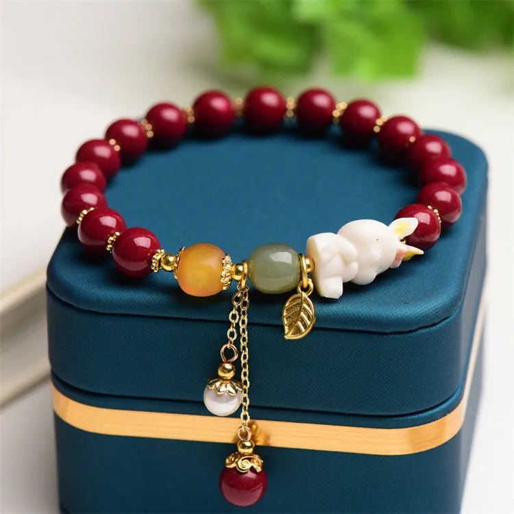 Traditional Chinese cinnabar bracelet with rabbit design in 8mm and 10mm bead size options.