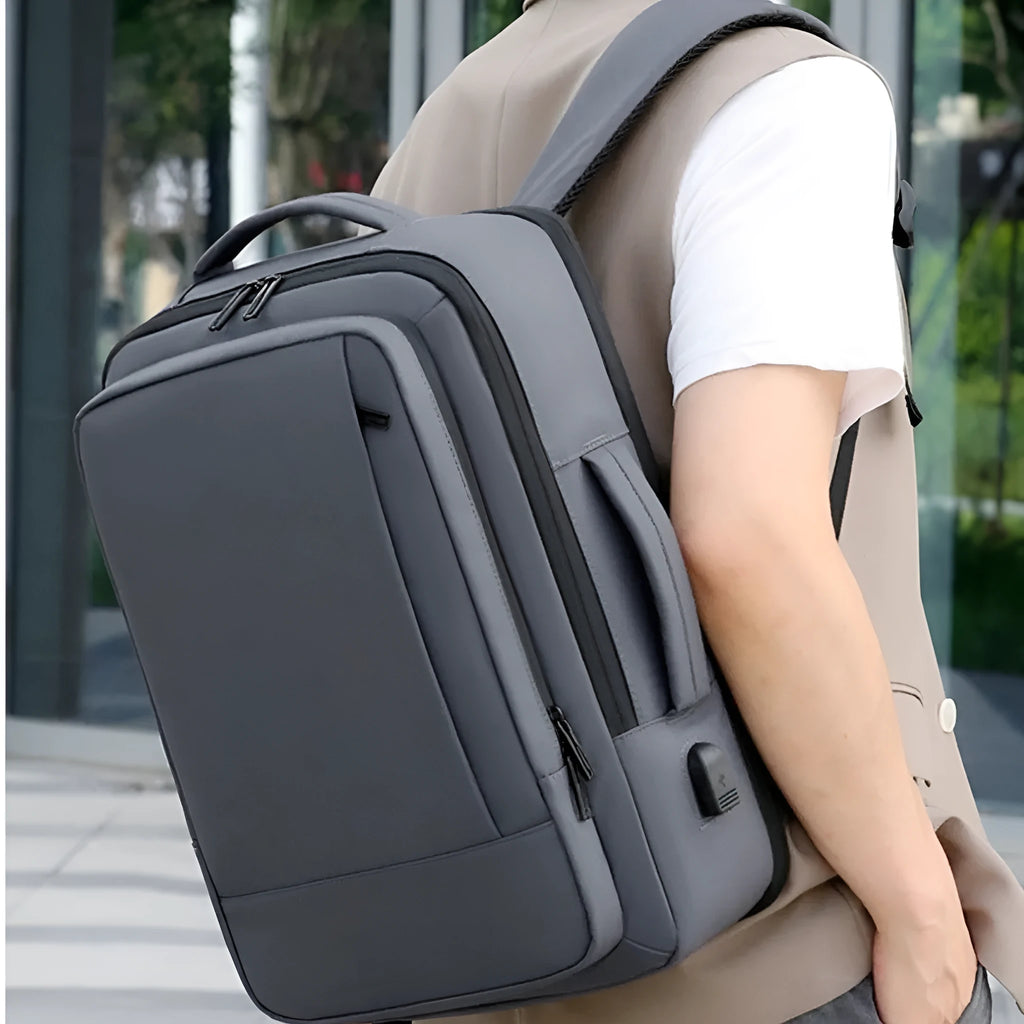Black Oxford cloth backpack with curved shoulder straps showing business travel styling