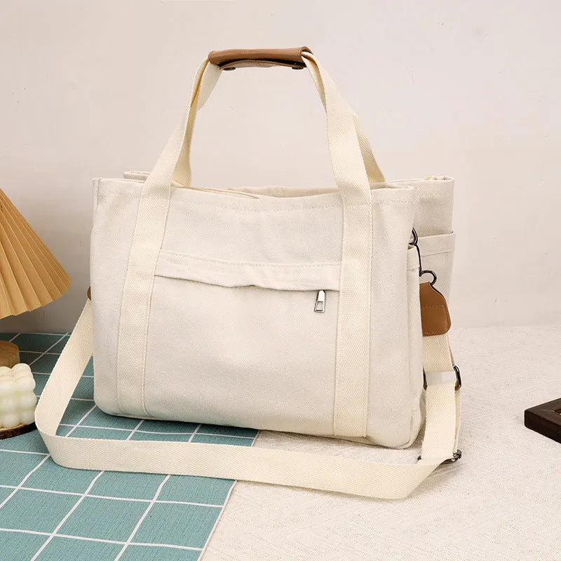 Large canvas tote bag with internal organisation pockets in neutral colour