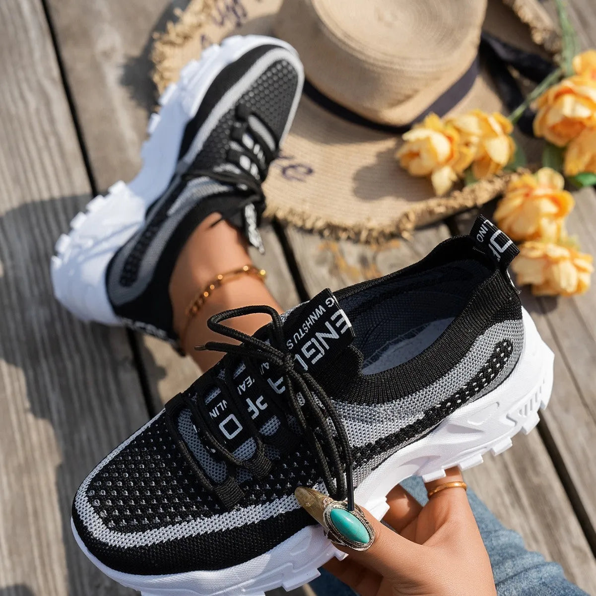 Women's Flyknit mesh lace-up sneakers in various colours with a round toe and rubber sole.