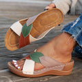 Women's black thick-soled slippers with a cross-strap and peep-toe design on a light background