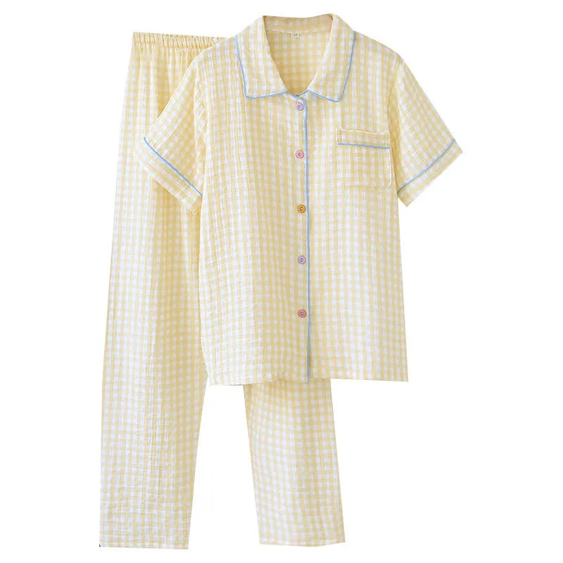 Women's yellow plaid print cotton short-sleeve trouser suit laid flat, showing top and loose-fit trousers.