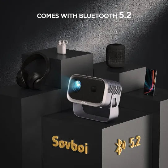 Portable 4K smart home theatre projector unit on a table, showing compact design and lens.