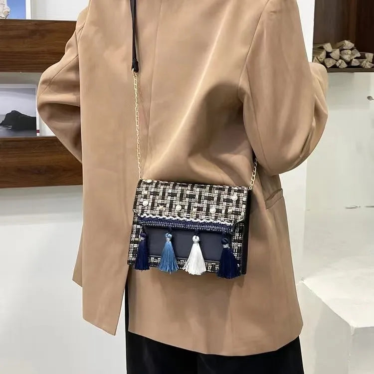 Ethnic-style horizontal square PU bag in beige with polyester lining, medium-hard structure, and flat lay on surface