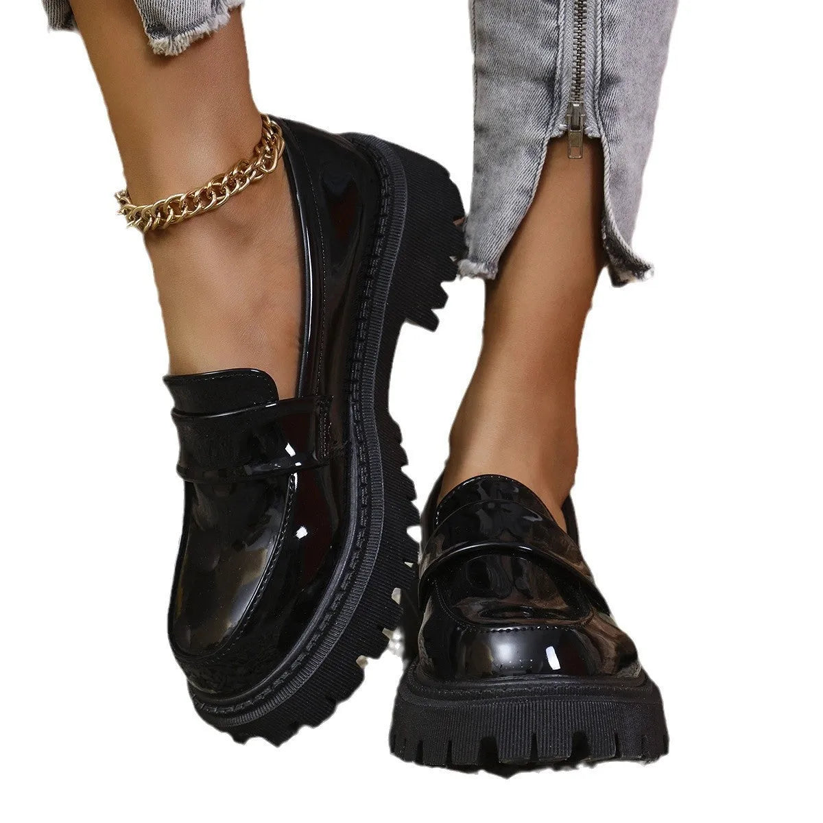 Black slip-on loafers with a chunky platform heel and thick rubber sole.
