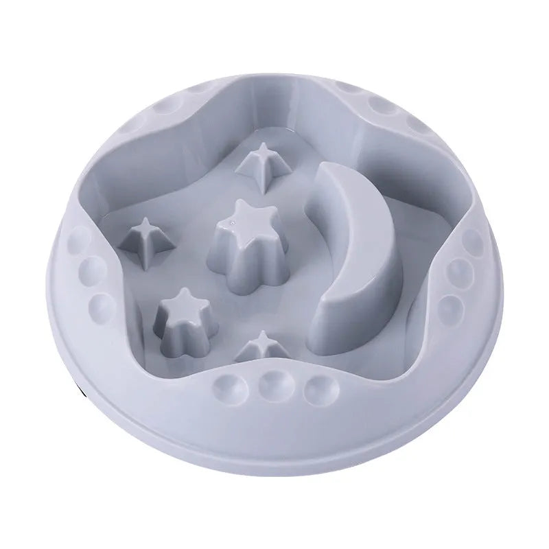 Blue slow feeder dog bowl with moon and star wing design and internal maze pattern.
