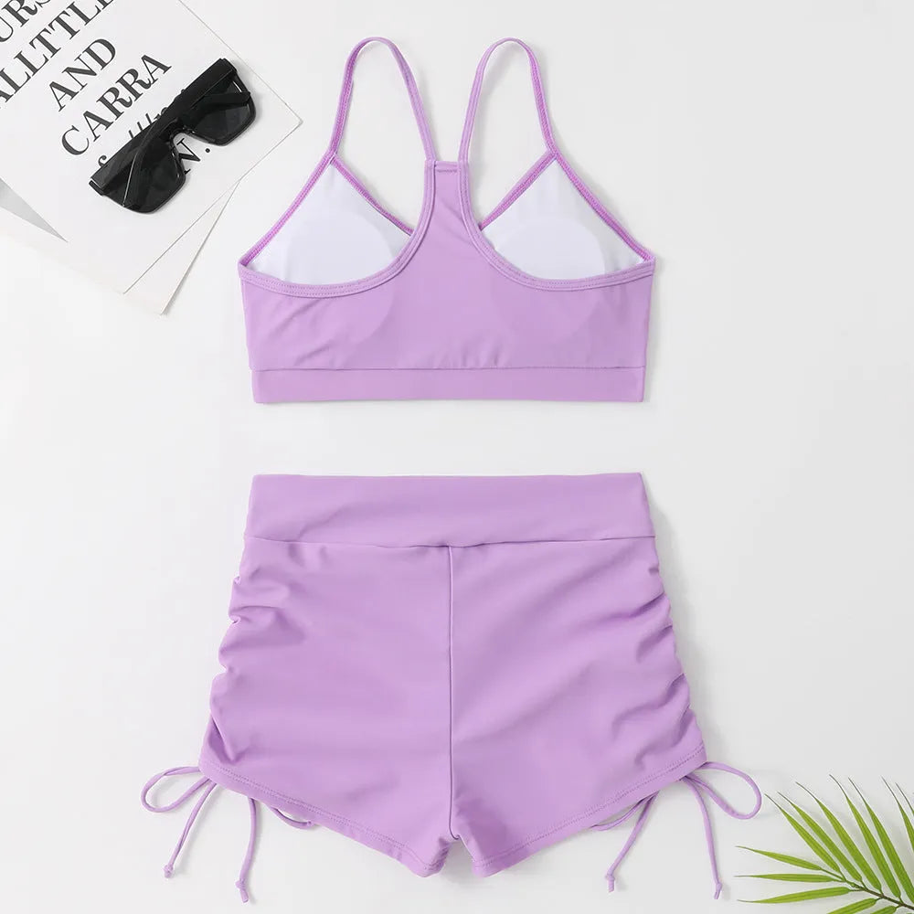 Purple high-waisted split bikini swimsuit for women on a white background.