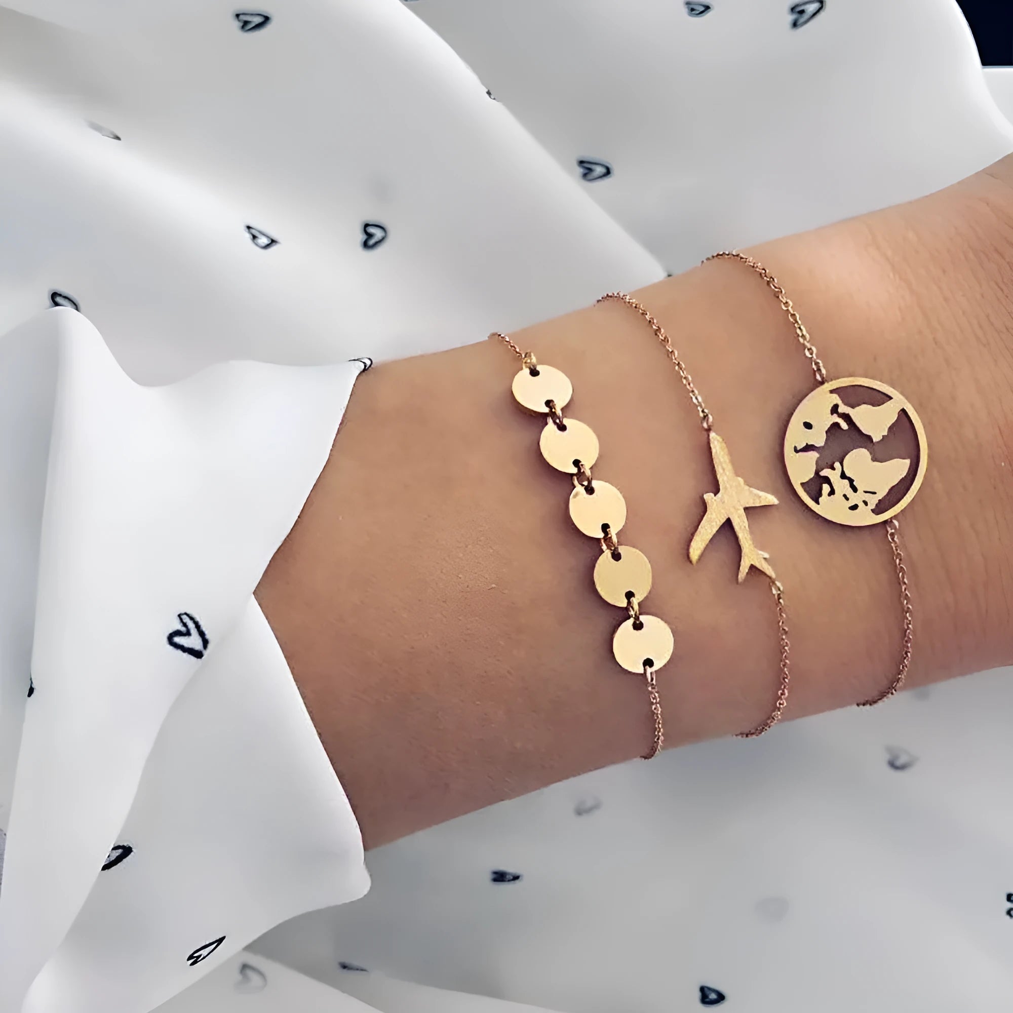 Three bohemian bracelets with heart-shaped aircraft map charms in alloy construction