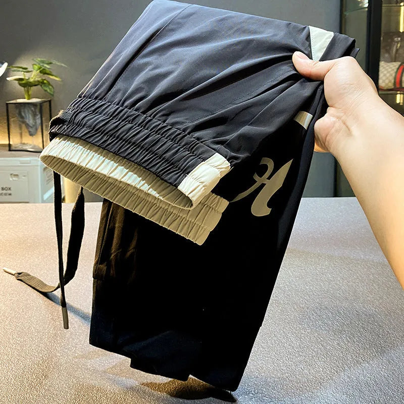 Black men's cropped casual trousers with ankle banding made from ultra-thin ice silk and cotton.