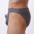 Men's loose-fit nylon briefs laid flat, showing light grey colour, elastic waistband, and breathable fabric texture.