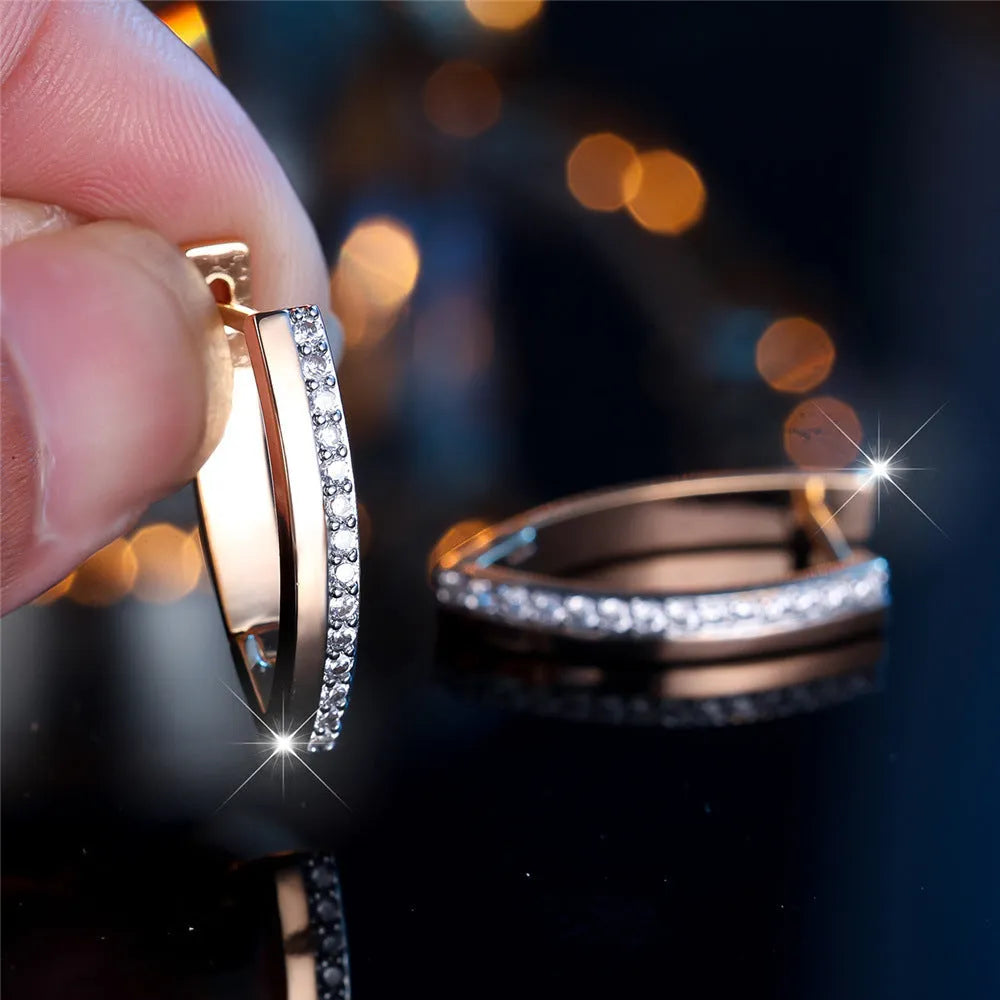 Geometric V-shaped women's ear clips in champagne gold with white diamond colour accents