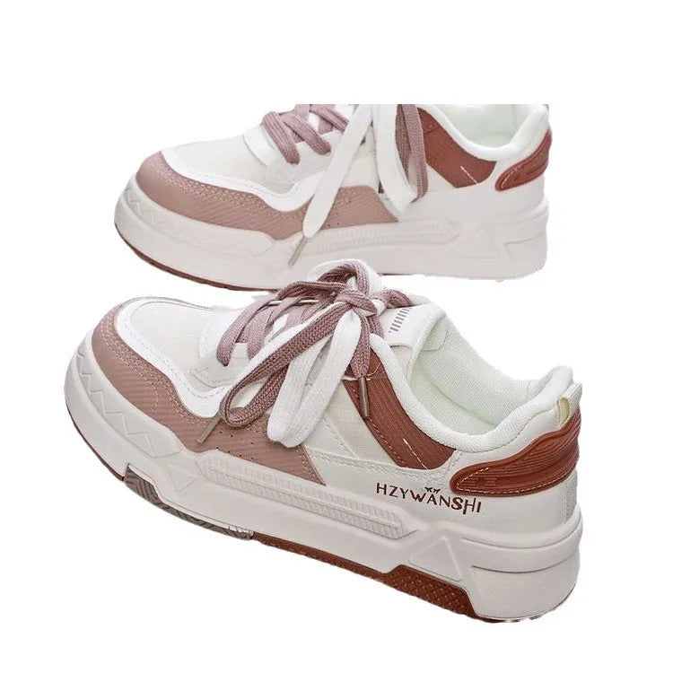 Beige children's lace-up trainers with cross straps over foot and thick rubber platform sole.