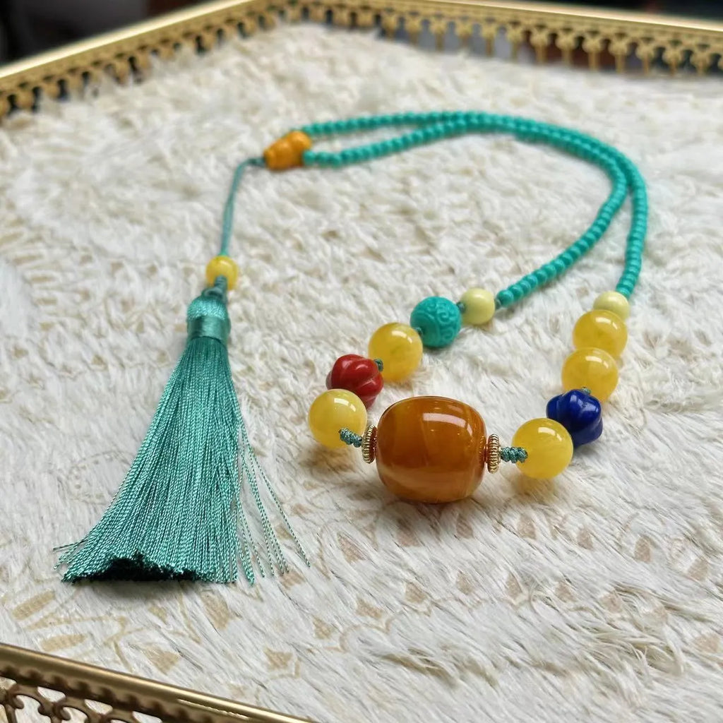 Turquoise stone lucky pendant necklace with detailed hand-woven mesh flower design on an adjustable ball bead chain.