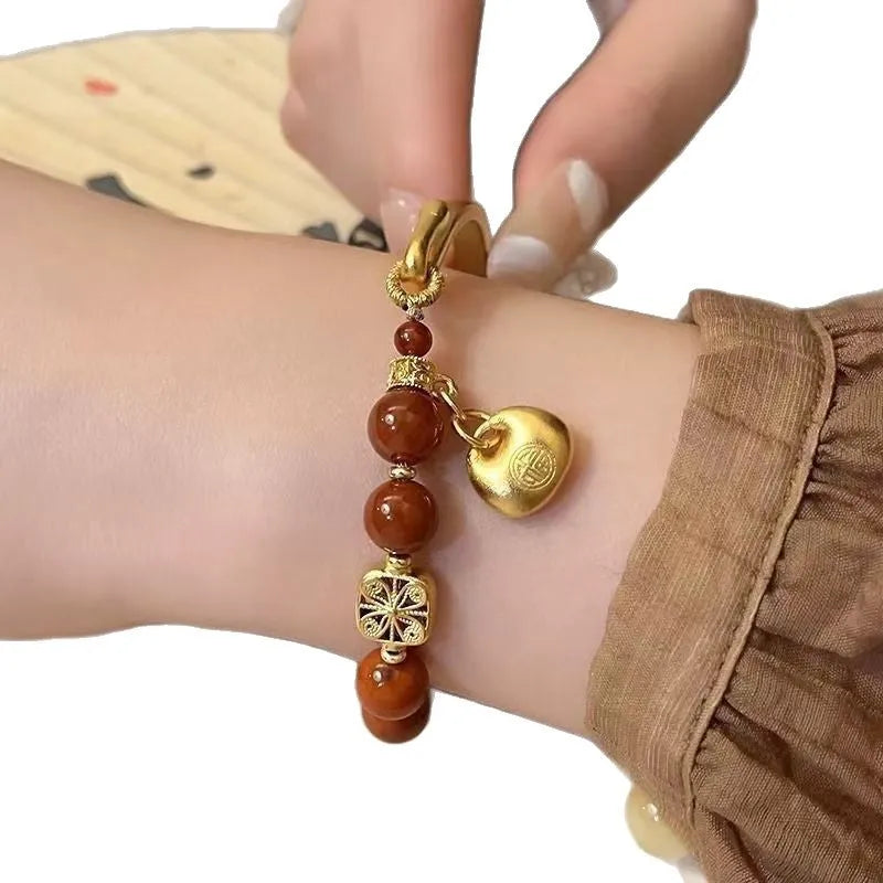 Golden South Red agate lucky bag bracelet with character ingot design for women