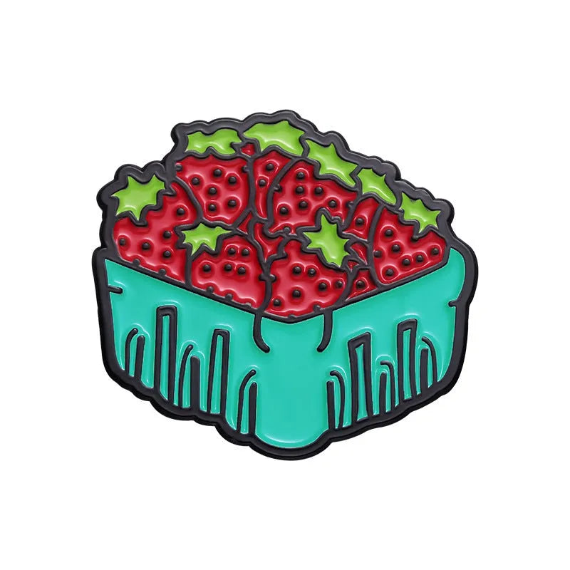 Colourful cartoon-style fruit metal brooch with a pin back on a denim jacket lapel.